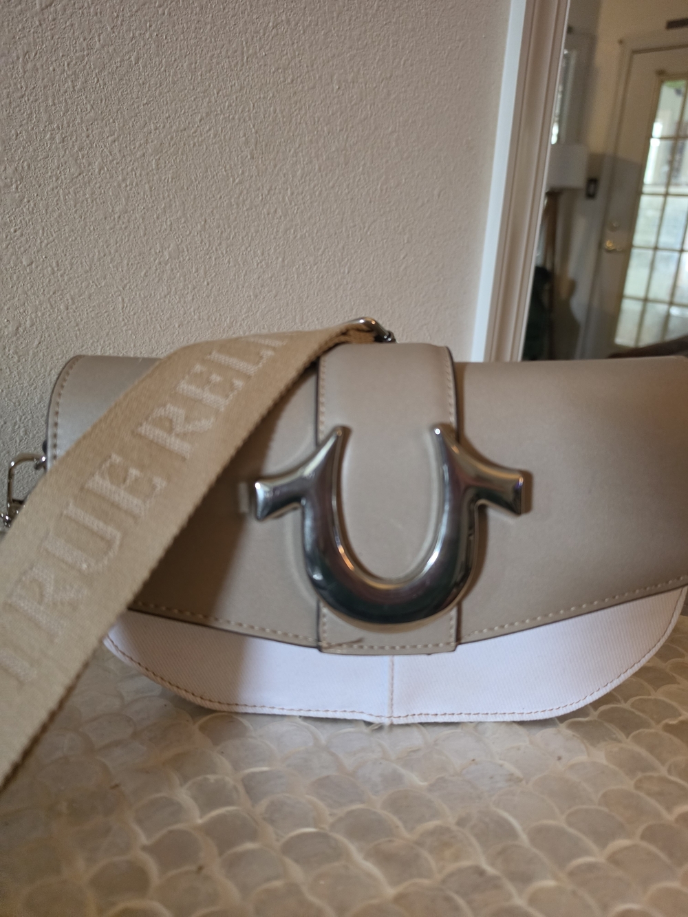 True Religion Two-Tone Beige and Cream Saddle Crossbody with Silver Horseshoe